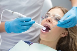 person using an intra oral camera on a patient