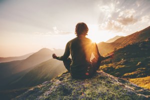 person sitting watching the sunrise