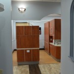 Interior hallway view showing wooden cabinetry and warm lighting in dental office corridor