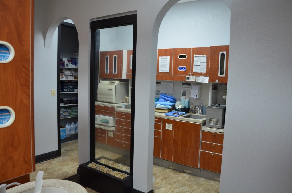 Sterilization and laboratory area with wooden cabinets, equipment, and organized workspace