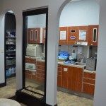 Sterilization and laboratory area with wooden cabinets, equipment, and organized workspace