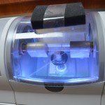 Dental curing or sterilization unit with blue UV light illumination chamber
