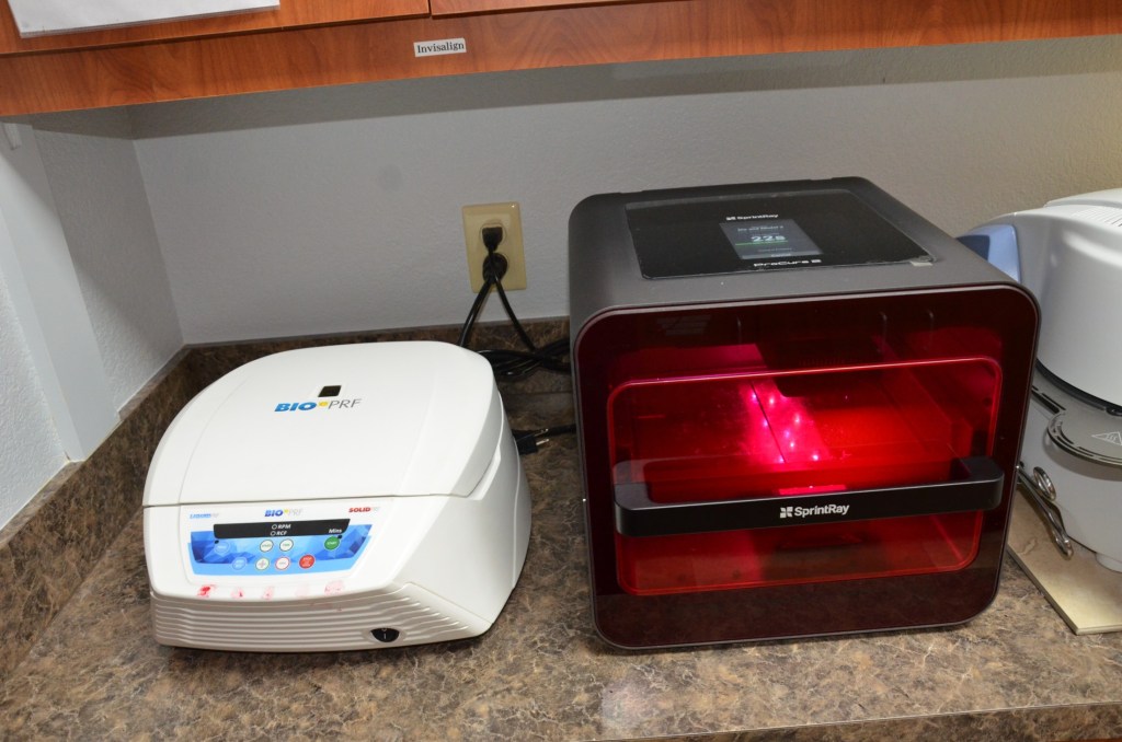 Dental laboratory equipment including white sterilization unit and red light curing chamber