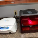 Dental laboratory equipment including white sterilization unit and red light curing chamber
